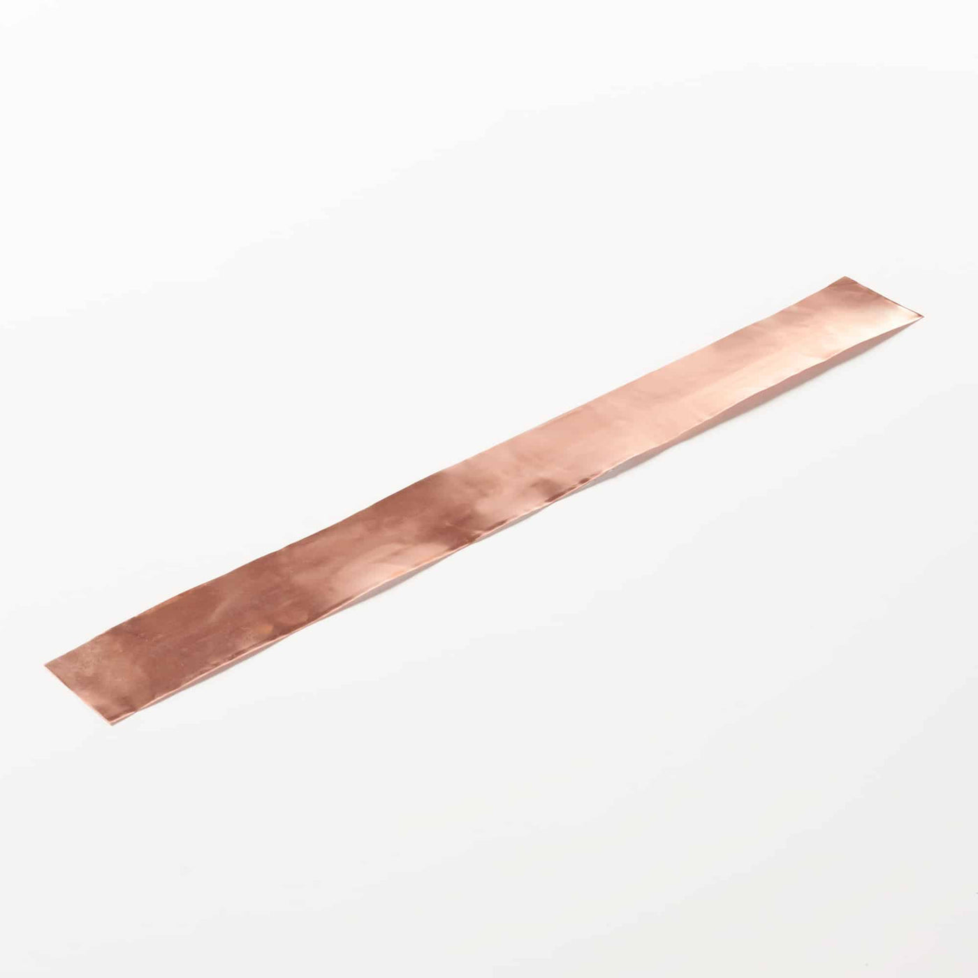 Photo of a copper strip against a white background.